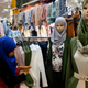 Photo: AP, women looking at face veils in Paris.